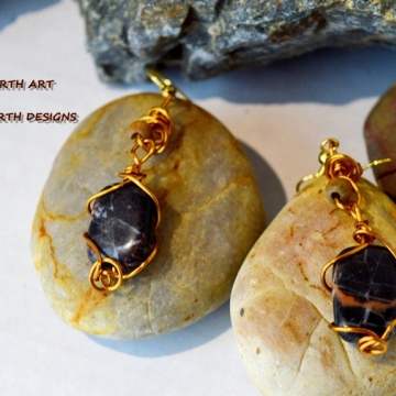 Banded BC agate drops hand wired with gold anodized copper wire there is a light oak bead mounted on the body it features gold ear wires Banded BC agate drops hand wired with gold anodized copper wire there is a light oak bead mounted on the body it features gold ear wires